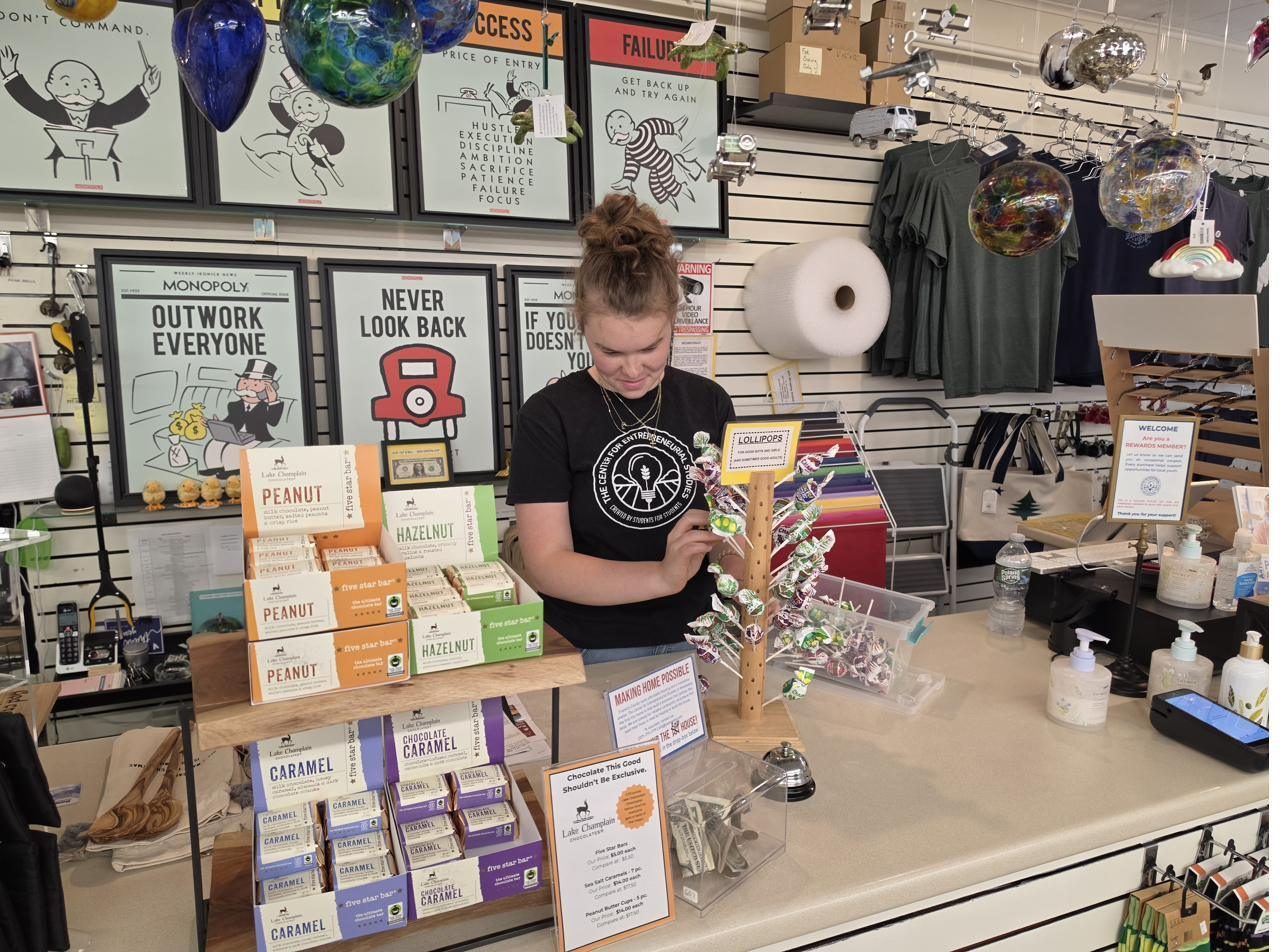 A young person stocking the counter at the CES store in Farmington